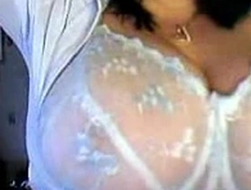 Attractive mother with large breasts undresses sensually