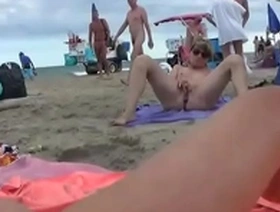 Public pussy play on the sandy shore