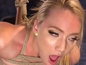 Blonde woman restrained and toyed in BDSM session
