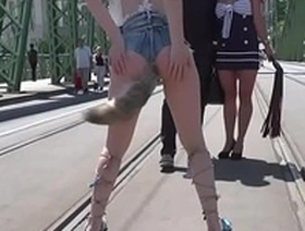 Slave flashing huge tits in public